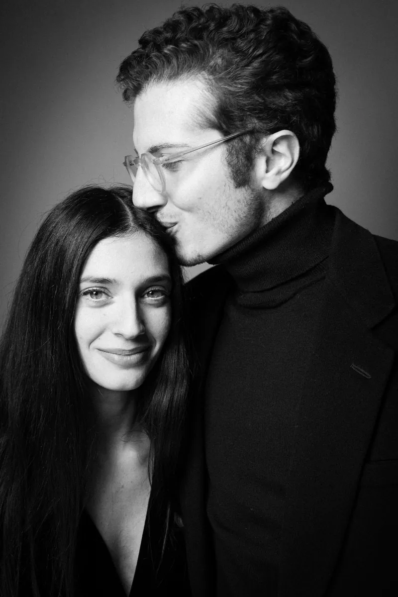 Ritratto di coppia in bianco e nero di Giorgio Galimberti: lui bacia la fronte di lei, che sorride